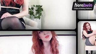 A buxom redhead in a Halloween spirit poses for